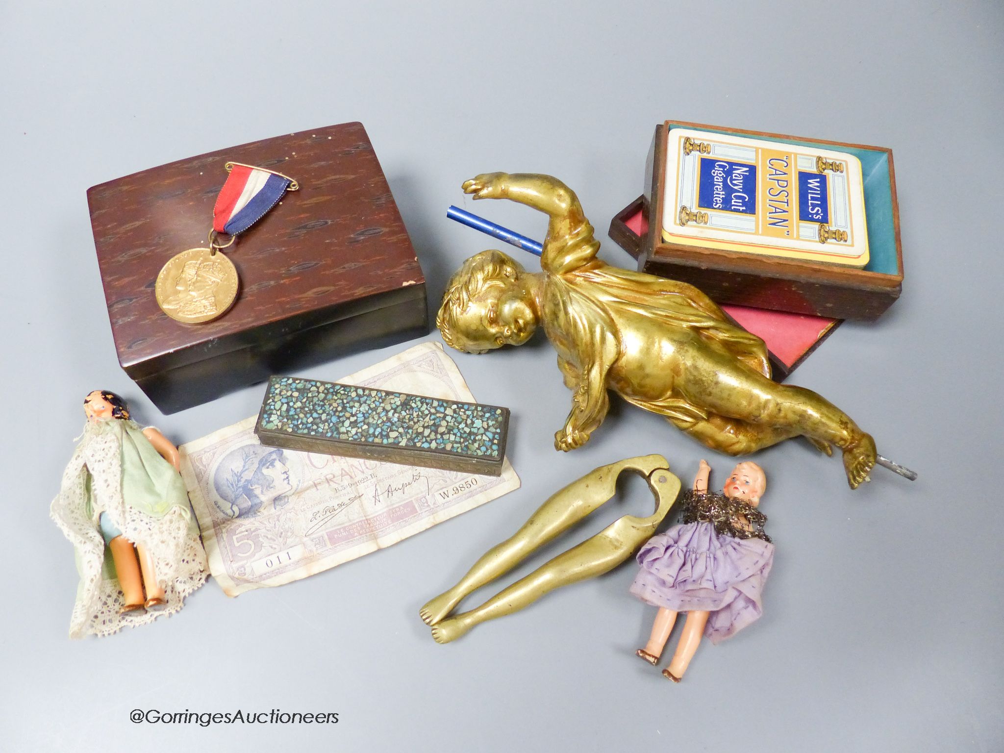 A 19th century gilt bronze figure surmount, brass 'Legs' nutcrackers and other items